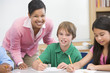 Teacher and pupil in elementary school classroom