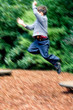 Young boy leaping high in the air, 