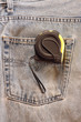 Measuring tape on blue jeans Measuring tape on blue jeans