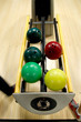 Bowling balls in the rack.