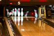 Bowling pins being knocked down. 