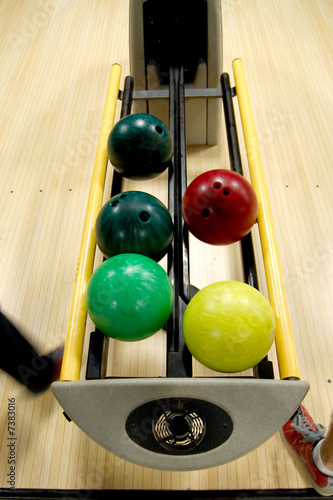 Photo: Bowling balls in the rack. Bowling balls in the rack.