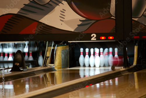 Photo: bowling pins being knocked down bowling pins being knocked down