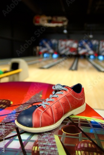 Photo: a bowling shoe on a table in alley a bowling shoe on a table in alley