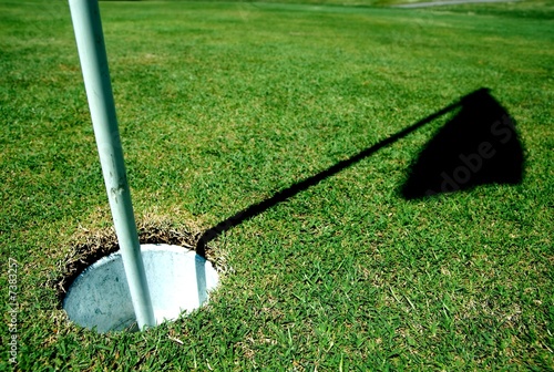 Photo: a golf course hole on green a golf course hole on green