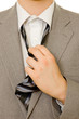 Stressful businessman untying his necktie