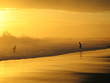 Foto: couple jouant dans les vagues au coucher du soleil couple jouant dans les vagues au coucher du soleil