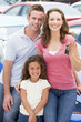 Young family collecting new car