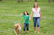 Photo: Mother and Daughter Walking the Dog in the Park Mother and Daughter Walking the Dog in the Park