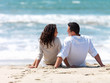 Couple sitting together on beach