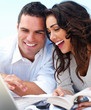 Happy young couple looking at laptop