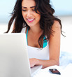 Smiling young woman using laptop
