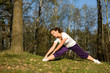 Sporty girl exercising on forest