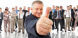 Older man giving the thumbs up in front of a crowd of people