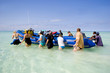 zanzibar diving tourists walking inflatable boat out of shallow zanzibar diving tourists walking inflatable boat out of shallow