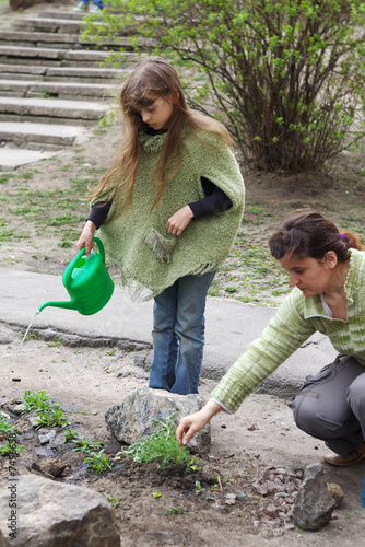 Photo: nice little girl in a spring garden nice little girl in a spring garden
