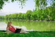 Photo: Woman with laptop outdoors Woman with laptop outdoors