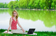 Photo: Woman with laptop outdoors Woman with laptop outdoors