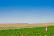 Girl playing with a colored kite, horizontal orientation