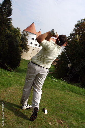 Photo: Golfer strikeing a ball. Golfer strikeing a ball.