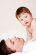 father with son lying on bed