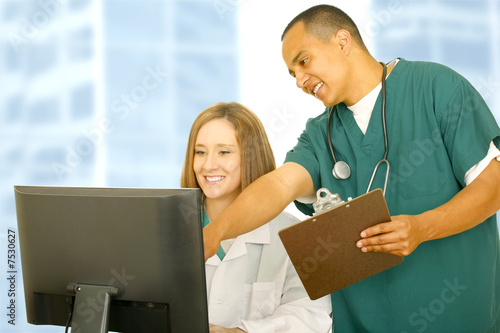 Nurse Pointing Computer Screen To Doctor