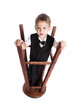 The little boy plays with the turned stool