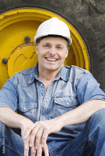 Photo: A happy smiling construction worker. A happy smiling construction worker.