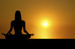 Images : front silhouette of woman meditating on sunset background