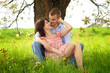 young and happy couple is cuddle on a meadow