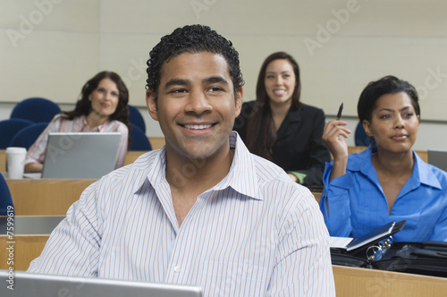 Photo: Business people sitting in classroom Business people sitting in classroom