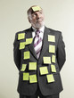 Businessman wearing sticky notes