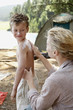 Mother Applying Suntan Lotion on Son