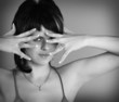 A woman takes her hand near face