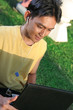 man with laptop and earphone on the garden