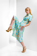 Beautiful Young woman in a flowers dress. In all growth. In the