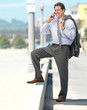 Business man talking on phone outside in the sun