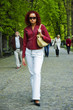 Beautiful young women walks in park