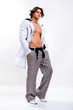 Young Man in a white shirt, jeans and boots. Denuded torso