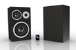Two black loudspeakers with a music player  