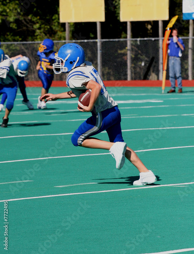 Photo: Youth Teen Football Player Running With the Ball Youth Teen Football Player Running With the Ball