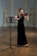 The beauty brunette plays the violin in concert hall