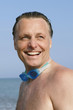 A happy laughing 44 year old man on beach