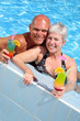 happy couple relaxing by the pool enjoying holidays happy couple relaxing by the pool enjoying holidays