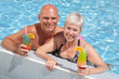 attractive couple relaxing by the pool attractive couple relaxing by the pool
