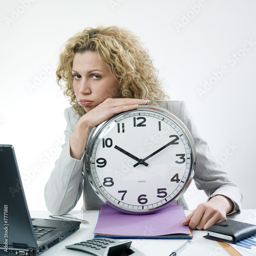 Photo: Bored woman with clock Bored woman with clock