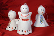 Angels family made of ceramics on a red cloth