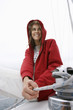 Young woman holding rope on yacht