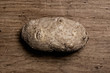 Potato on old wooden table.