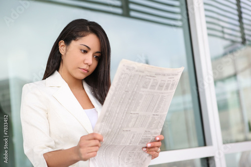 Photo: Pretty Hispanic Woman Reading Newspaper Pretty Hispanic Woman Reading Newspaper